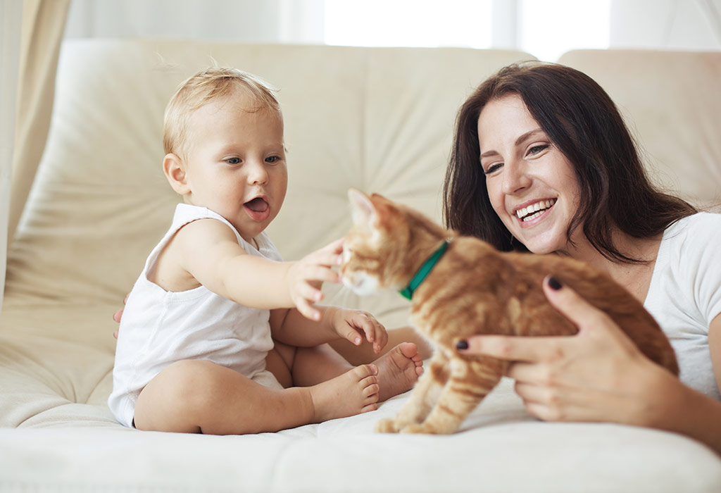 Mother and child playing with their pet cat